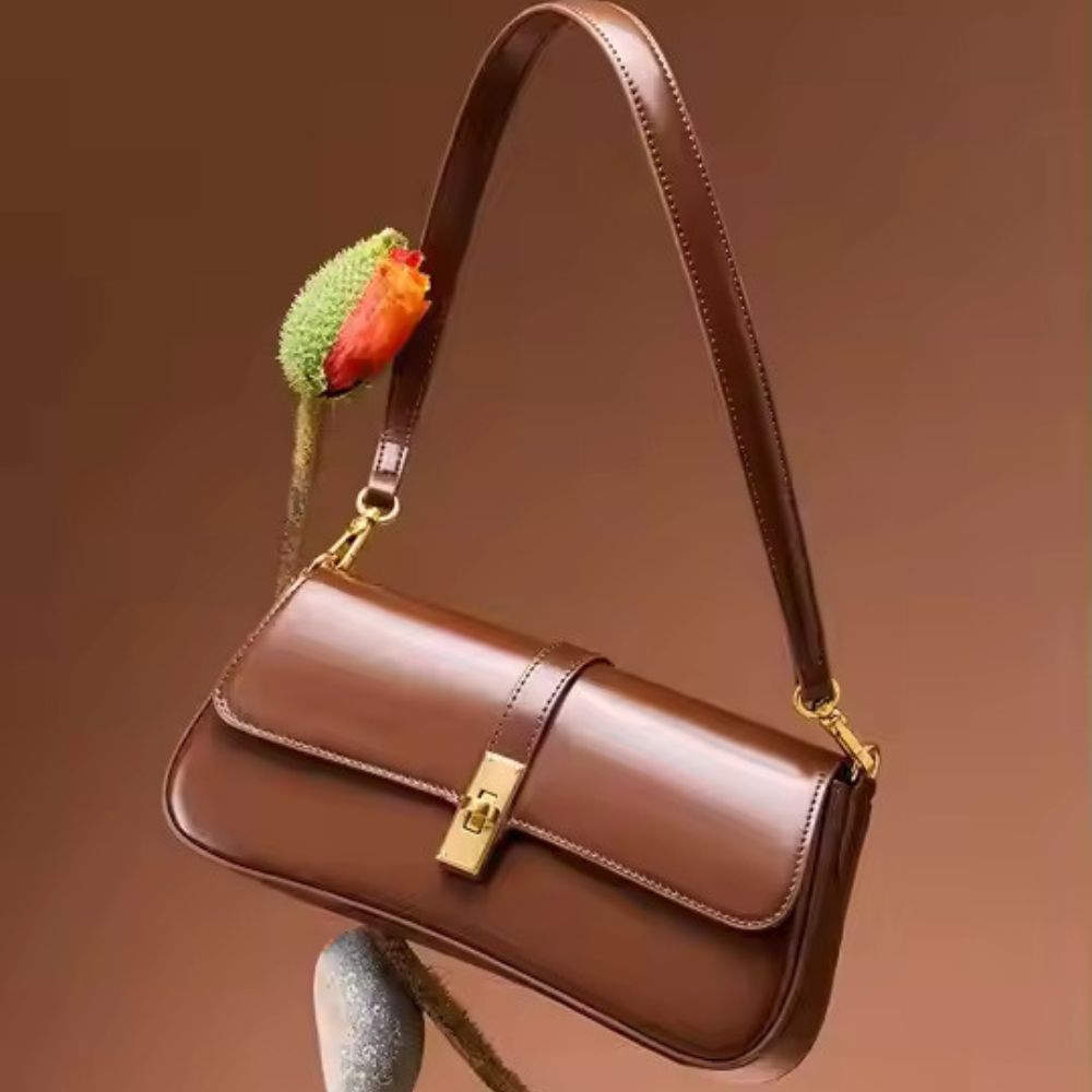 Elevate your everyday style with the Ladies’ New One-Shoulder Crossbody Bag, designed for modern women who love classic elegance and compact functionality. This beautifully crafted shoulder purse is made from premium cowhide leather, known for its durability and natural texture. The clamshell-style flap gives it a timeless, structured look, while the sleek profile makes it perfect for everything from daily commutes to casual meetups or dinner outings. Available in three sophisticated colors—Black, Brown, and Wine Red—this bag complements a variety of outfits and occasions. The compact yet practical size (26 × 12 × 5 cm) holds your essentials securely without being bulky. Whether you're a fan of European vintage or minimalist charm, this crossbody shoulder bag adds a graceful touch to your wardrobe. Features: Sleek and stylish retro silhouette Soft cowhide leather finish Magnetic clamshell closure for security Ideal for everyday use or evening fashion Lightweight and easy to carry Add this versatile leather crossbody bag to your collection and enjoy a perfect balance of classic design and modern convenience.